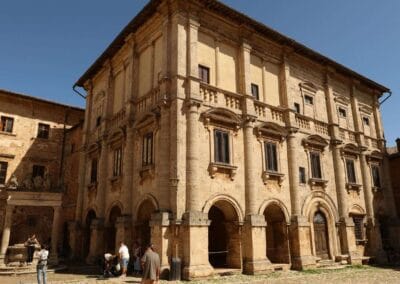 a group of people standing outside of a Renaissance building