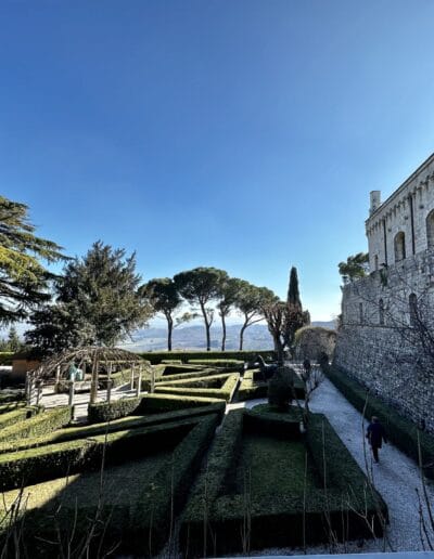 Villa Poggiano, a stone fortress with a garden and trees