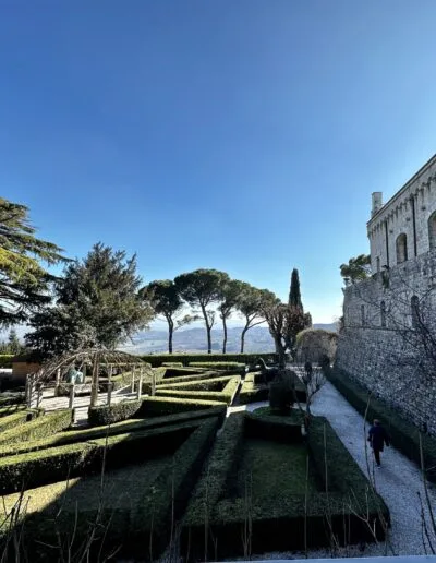 Villa Poggiano, a stone fortress with a garden and trees