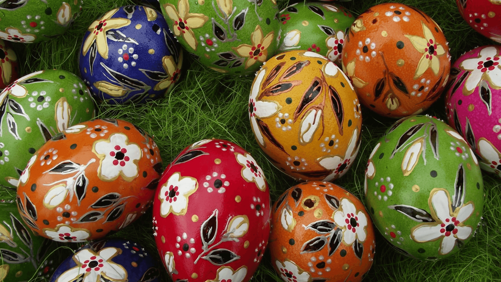 Multicolored hand hand painted eggs in grass